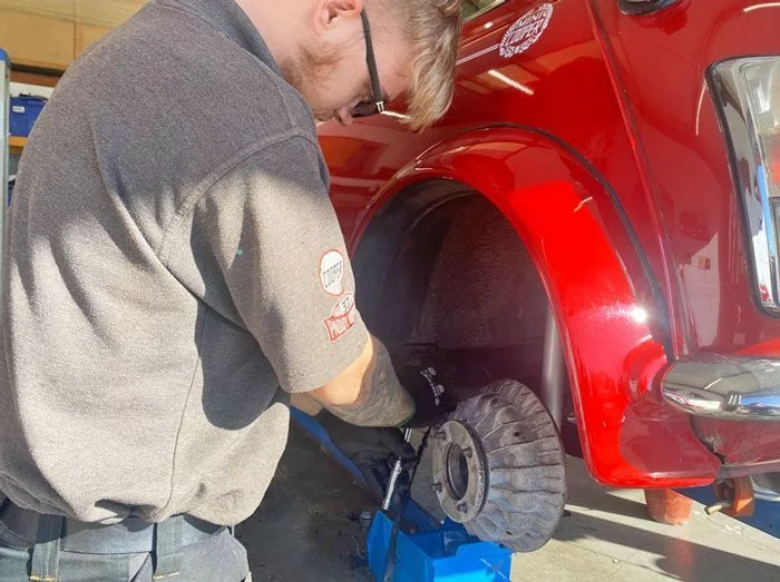 Mini Sport Technician Working on Rear Brakes